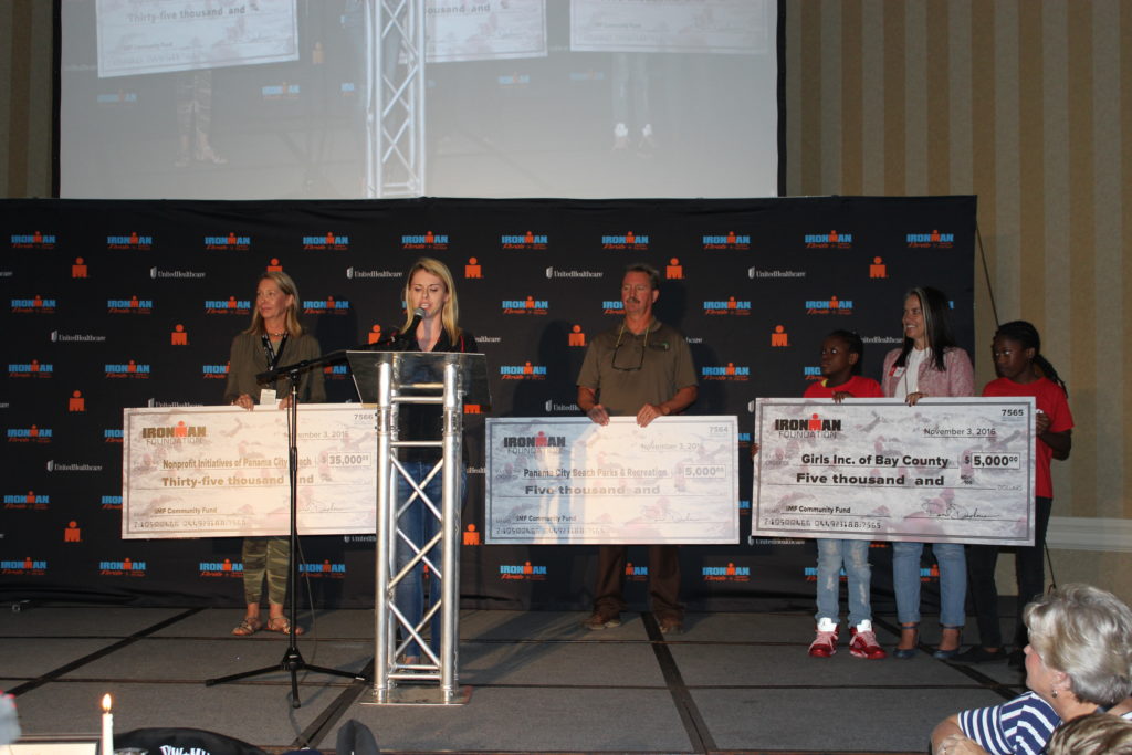 Fundraising Programs Manager, Whitney Staloch, presents our IMF Grant Beneficiaries with checks totaling over $88,000 at the IMFL Athlete Welcome Banquet!