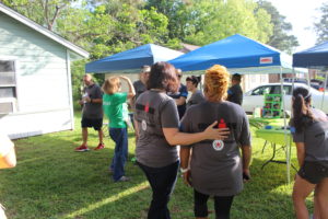 IRONMAN Foundation Community Relations Manager, Sarah Hartmann, spending time with Ms. Angela, the lovely homeowner whose house we restored. Prior to project day, Rebuilding Together Houston replaced Ms. Angela's roof with a Community Grant from the IRONMAN Foundation.