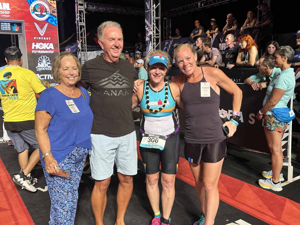 Elizabeth Wood and her supporters gather at the the finish line of the IRONMAN World Championship on October 6, 2022 in Kailua-Kona, HI. 