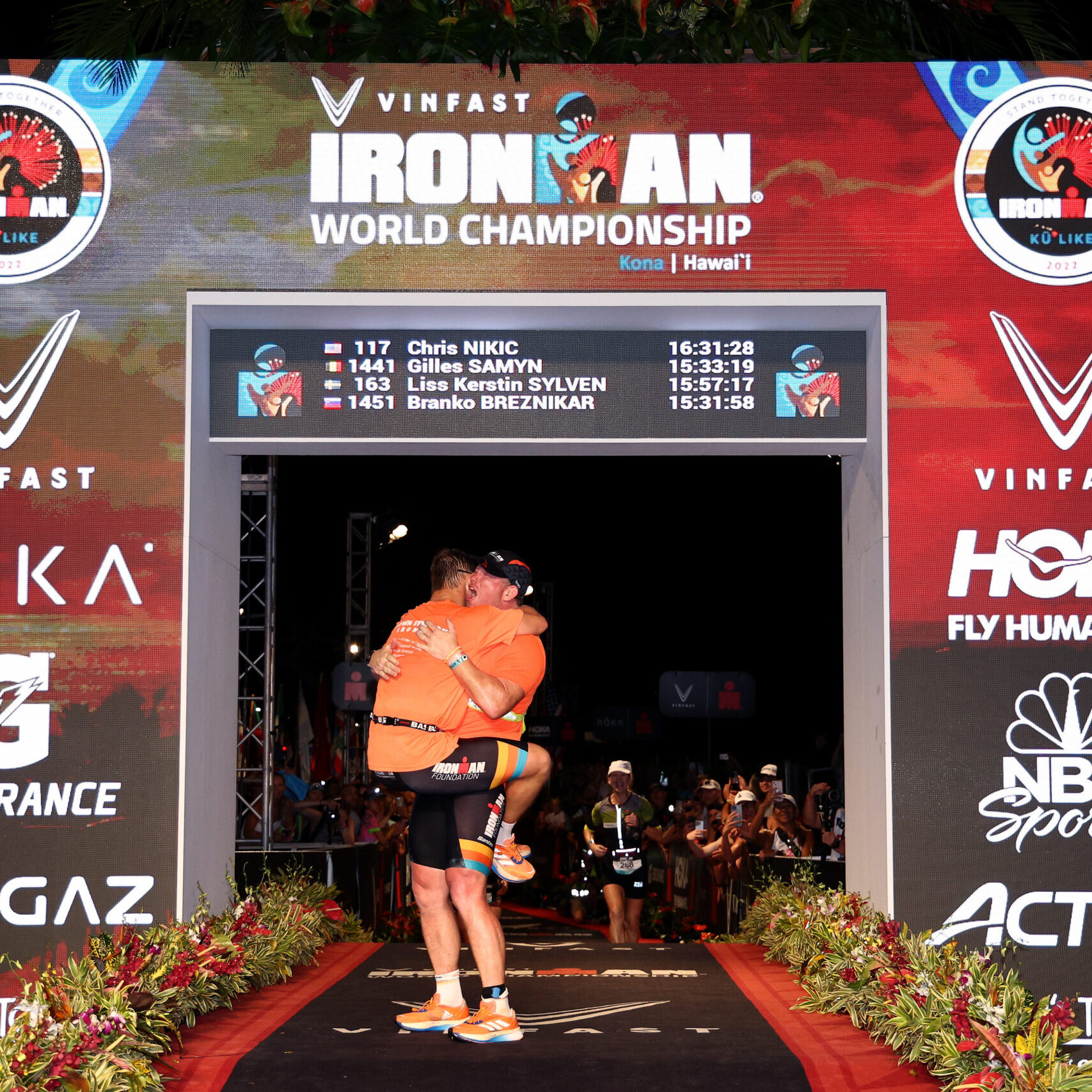 KAILUA KONA, HAWAII - OCTOBER 06: Chris Nikic and guide Dan Grieb celebrate after finishing the Ironman World Championships on October 06, 2022 in Kailua Kona, Hawaii. (Photo by Tom Pennington/Getty Images for IRONMAN)