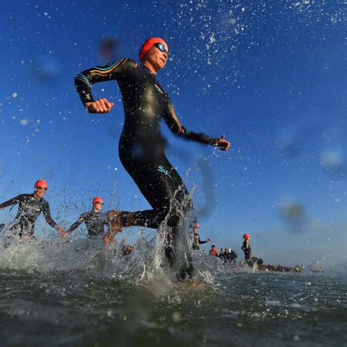 PORT ELIZABETH - SEPTEMBER 1:  General view of Age Group Athletes entering the water for the swim start during the Isuzu IRONMAN 70.3 World Championship Women in Port Elizabeth, South Africa on September 1, 2018. Over 4,500 athletes from over 100 countries will be represented in this years 70.3 World Championship. (Photo by Donald Miralle/Getty Images for IRONMAN).
