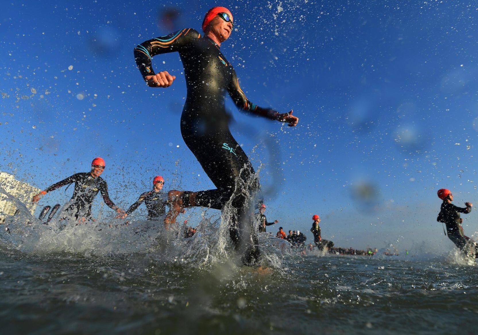 PORT ELIZABETH - SEPTEMBER 1:  General view of Age Group Athletes entering the water for the swim start during the Isuzu IRONMAN 70.3 World Championship Women in Port Elizabeth, South Africa on September 1, 2018. Over 4,500 athletes from over 100 countries will be represented in this years 70.3 World Championship. (Photo by Donald Miralle/Getty Images for IRONMAN).